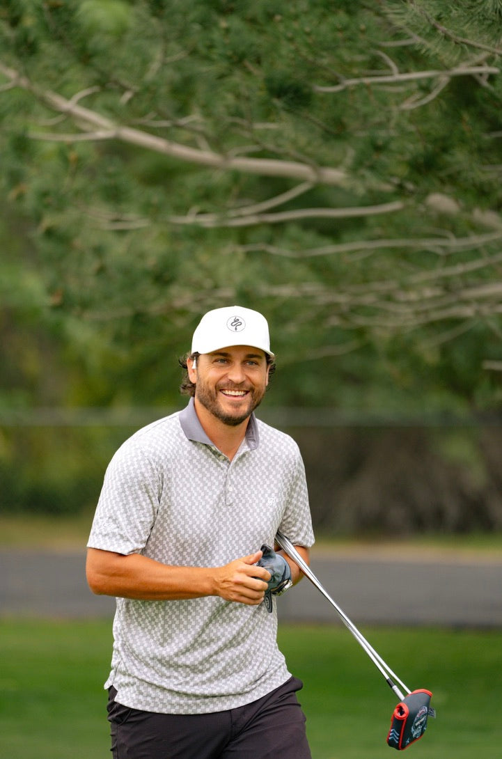 Ryan Evans, owner of Alpha Zen, smiling on a golf course